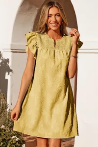 Detailed view of yellow summer dress with V-neck ruffles and elegant floral embroidery