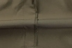 Detailed view of durable olive green ripstop fabric and reinforced seam stitching for cargo pants