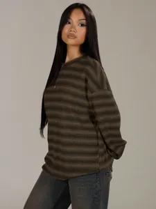 Close-up detail of a fashionable oversized striped sweatshirt with a classic round neck