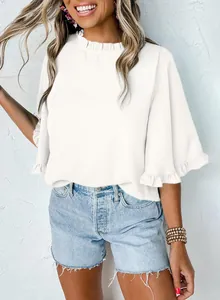 Detail shot of elegant white summer blouse with ruffled collar and half sleeves