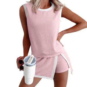 Casual pink ribbed knit two-piece set with sleeveless top and side-split shorts.