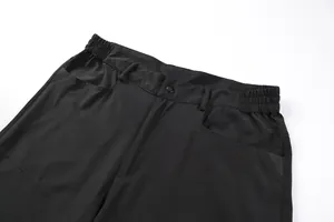 Close-up of black tactical cargo shorts waist with elastic band and pocket details