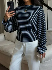Detail of a blue and black striped long-sleeve t-shirt with batwing sleeves and round neck.