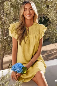 Close-up of yellow summer dress featuring double ruffle sleeves and smocked floral texture