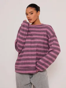 Close-up detail of oversized striped crew neck sweater in pink and purple tones