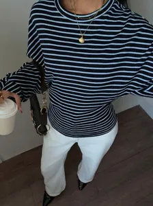 Detailed view of the blue and black striped long sleeve shirt with batwing sleeves