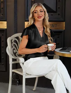 Elegant black V-neck satin blouse detail showing ruffled sleeves and silky texture.
