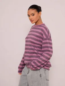 Close-up detail of a soft purple striped oversized crewneck sweatshirt on model