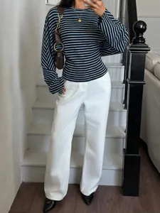 Close-up of the stylish striped batwing sleeve t-shirt with a round neck in a lifestyle setting