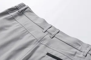 Detail shot of grey men's outdoor shorts showing the elastic waistband and pocket