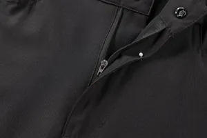 Close-up of durable zipper and ripstop fabric on men's black tactical shorts.