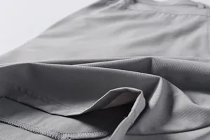 Close-up of grey ripstop fabric texture and stitching on these men's outdoor shorts