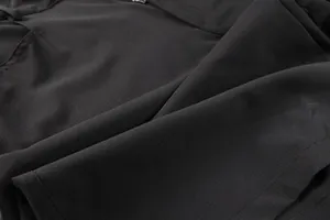 Macro close-up view of durable black ripstop fabric on men's tactical cargo shorts