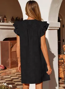 Detailed back view of a black summer dress featuring floral textures and ruffled sleeves