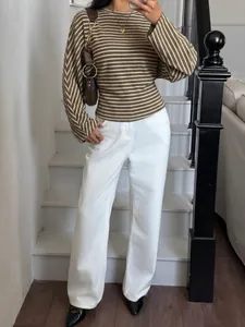 Close-up detail showing the striped pattern and batwing sleeve of this brown T-shirt.