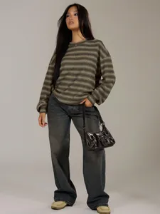 Oversized striped round neck long sleeve sweatshirt worn by model with wide jeans