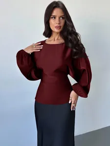 Detailed view of burgundy satin batwing sleeve top with elegant waist tie design