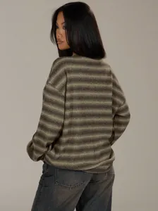 Oversized brown striped crewneck sweater worn by model from behind in studio view.