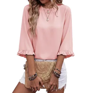 Elegant light pink blouse featuring a round neck and feminine ruffle trim short sleeves