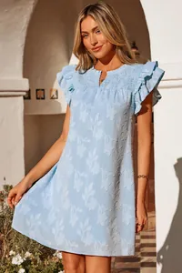 Detailed view of floral jacquard texture and ruffled sleeves on blue summer dress