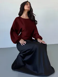 Elegant burgundy satin long sleeve batwing top with smooth texture finish.