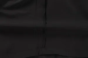 Close-up of black cargo shorts fabric showing detailed stitching and grid texture