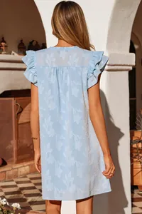 Back view of light blue summer mini dress with double ruffle sleeves and floral pattern