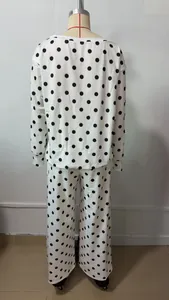 Back view of a white two-piece loungewear set with black polka dots on a mannequin.