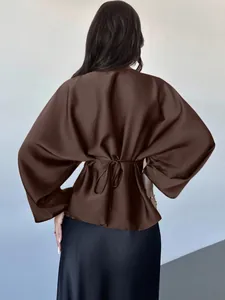 Back view of elegant brown satin batwing sleeve blouse with adjustable tie waist detail