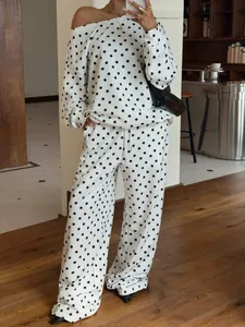 Close-up of stylish white polka dot two-piece sweatshirt set with slanted collar design
