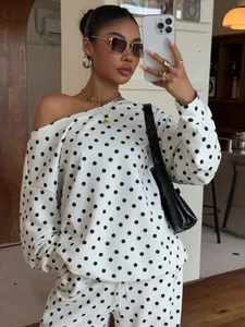 Casual white and black polka dot two-piece set with off-shoulder sweatshirt and pants