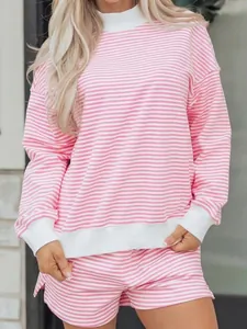 Detail of pink striped oversized sweatshirt set with white ribbed mock neck and cuffs
