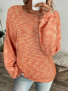 Close-up of vibrant orange waffle knit long-sleeve top with relaxed fit and soft texture