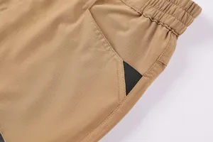 Close-up detail of men's khaki cargo shorts showing durable ripstop fabric and pocket