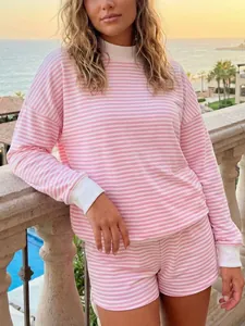 Cozy pink and white horizontal striped long sleeve sweatshirt and shorts set on a model