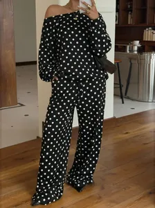 Stylish black sweatshirt set with white polka dots featuring a trendy slanted collar design