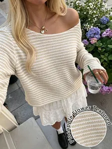 Close-up of the pineapple flower textured pattern on a striped long sleeve knit sweater