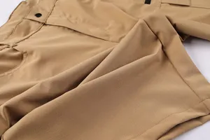 Detail view of khaki ripstop fabric and pocket stitching on men's tactical cargo shorts.