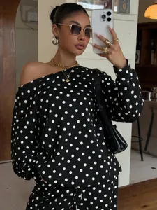 Chic women's two-piece lounge set featuring a polka dot off-shoulder sweatshirt and matching pants.