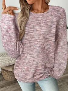 Close-up of the textured waffle-knit fabric on a colorful loose-fit long-sleeved shirt
