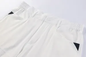 Detailed close-up view of white men's cargo shorts showing elastic waist and utility pockets