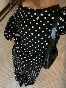 Detailed view of the black and white polka dot lounge set featuring an off-shoulder top.