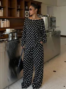 Stylish two-piece polka dot lounge set with off-shoulder top and wide-leg trousers