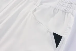 Detailed close-up showing the pocket design and fabric texture of white men's cargo shorts