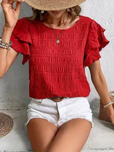 Lifestyle detail of a red round neck top with smocked texture and double ruffle sleeves.