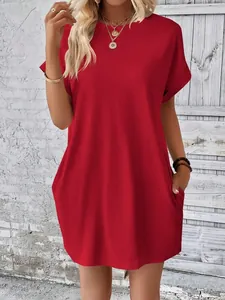 Dettaglio di un abito a maglietta rosso ampio con tasche laterali e scollo rotondo
