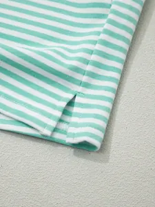 Close-up of mint green striped cotton sweatshirt showing side slit and fabric texture.