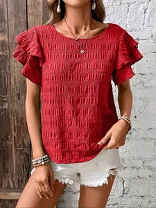 Macro detail of the red smocked fabric texture and double flutter ruffled sleeves on this top