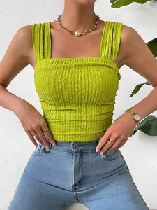 Detail shot of lime green textured smocked crop top with square neck and wide straps.