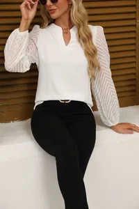Close-up detail of white V-neck chiffon blouse featuring elegant lace texture on sleeves